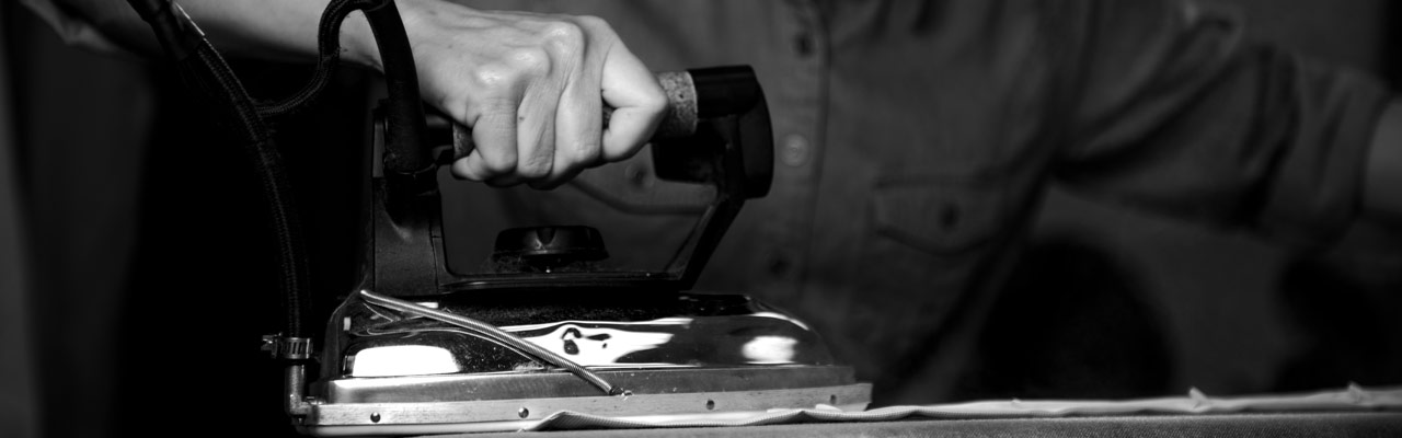 Zegna Workers Hand Pressing a Garment